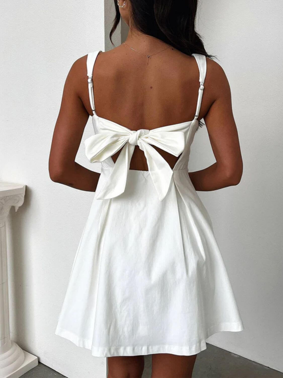 Devine bow back square neck mini dress with a chic and playful design, perfect for any occasion, available at 6i6.com