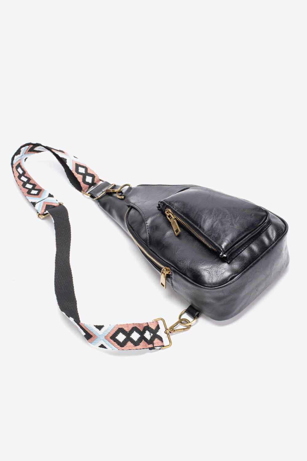 All The Feels PU leather sling bag in black with adjustable strap and front zipper pocket, featuring a stylish geometric strap design.