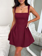 Devine bow back square neck mini dress with a chic and playful design, perfect for any occasion, available at 6i6.com
