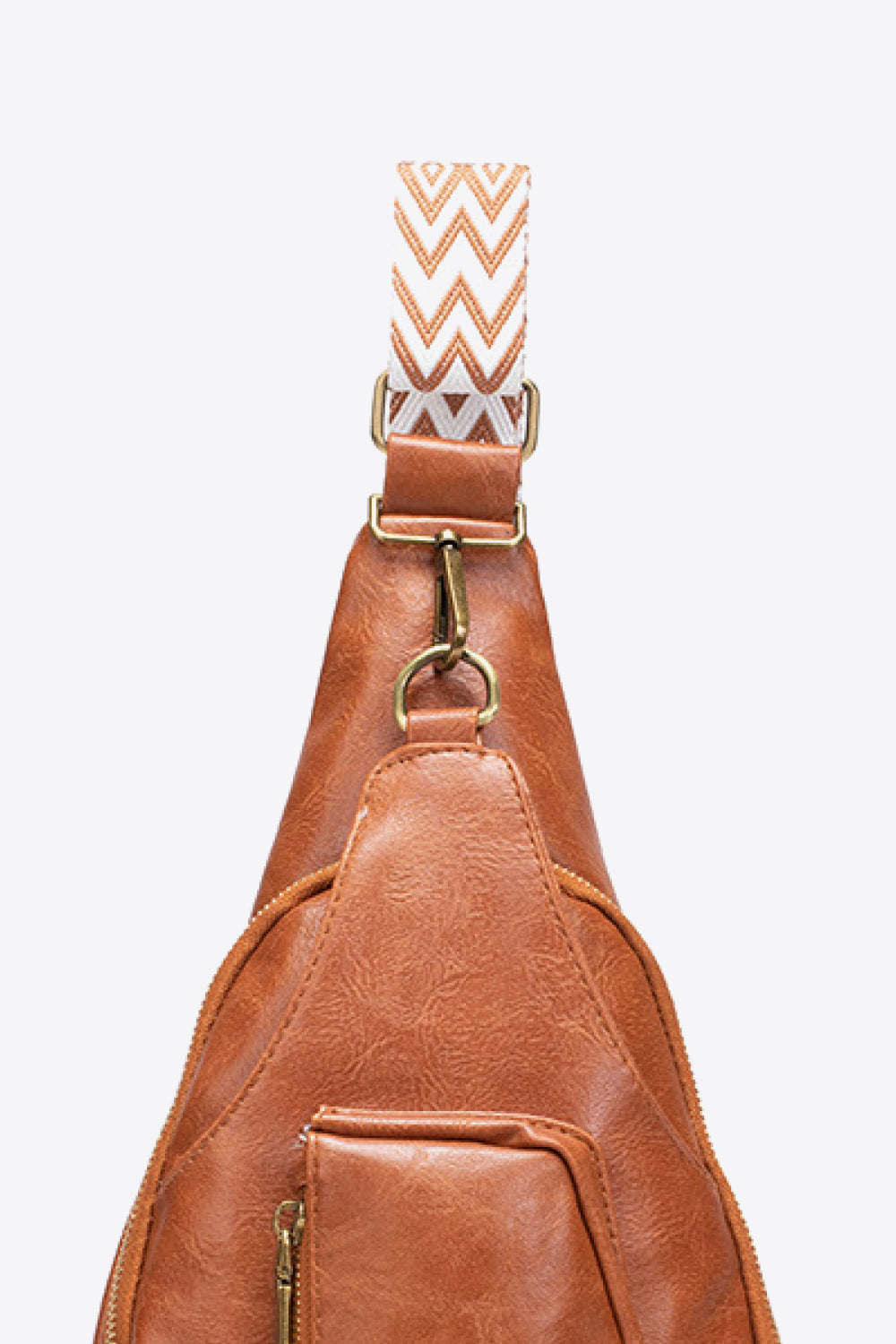 Adjustable strap of All The Feels PU leather sling bag in tan with zigzag pattern and gold hardware.