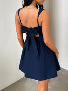 Devine bow back square neck mini dress with a chic and playful design, perfect for any occasion, available at 6i6.com