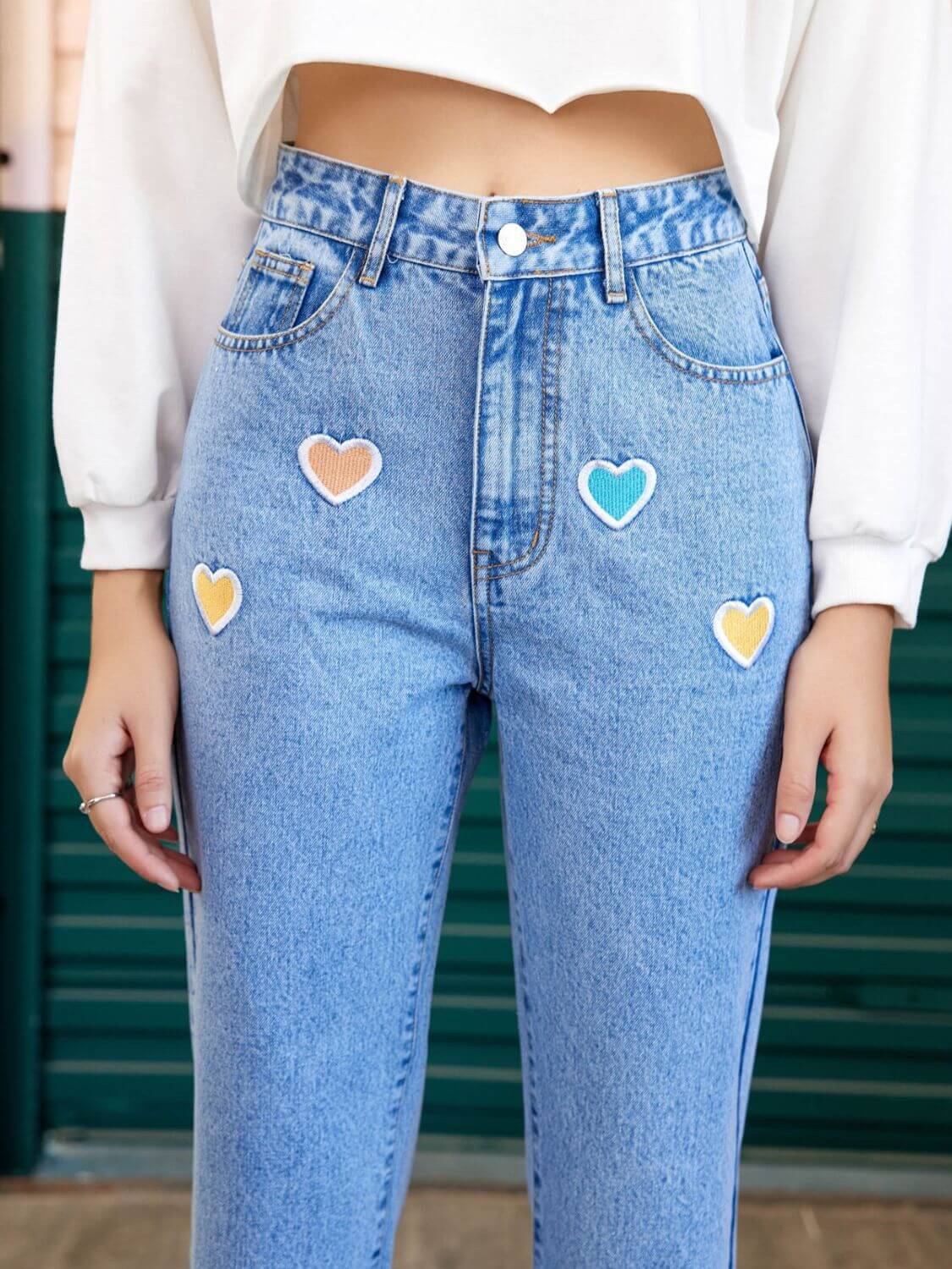 Heart-shaped detail on straight leg jeans with side pockets, designed for a stylish and comfortable fit, available at 6i6.com