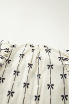 Bow Print Tie Neck Short Sleeve Blouse for women from 6i6.com, a stylish and versatile top for casual or office wear.