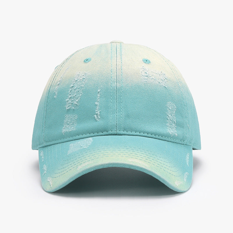 Adjustable cotton baseball hat in light blue with distressed design, perfect for casual wear and outdoor activities.