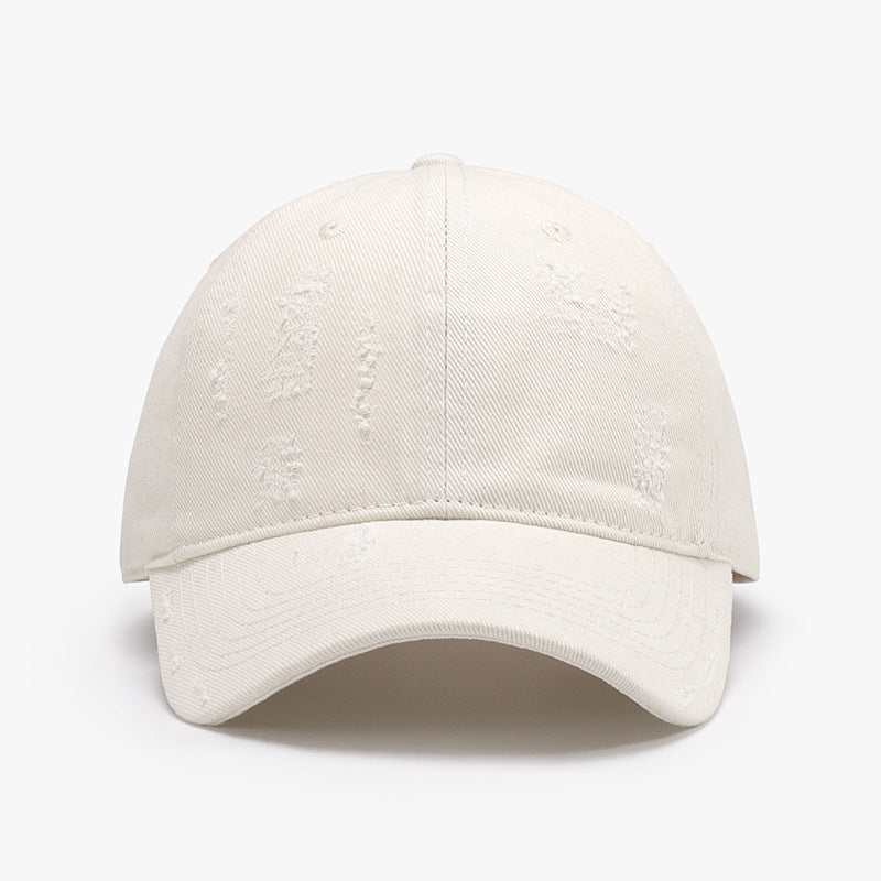 Adjustable cotton baseball hat in off-white with distressed design, featuring a 2.8-inch brim and 22-24.4-inch circumference.