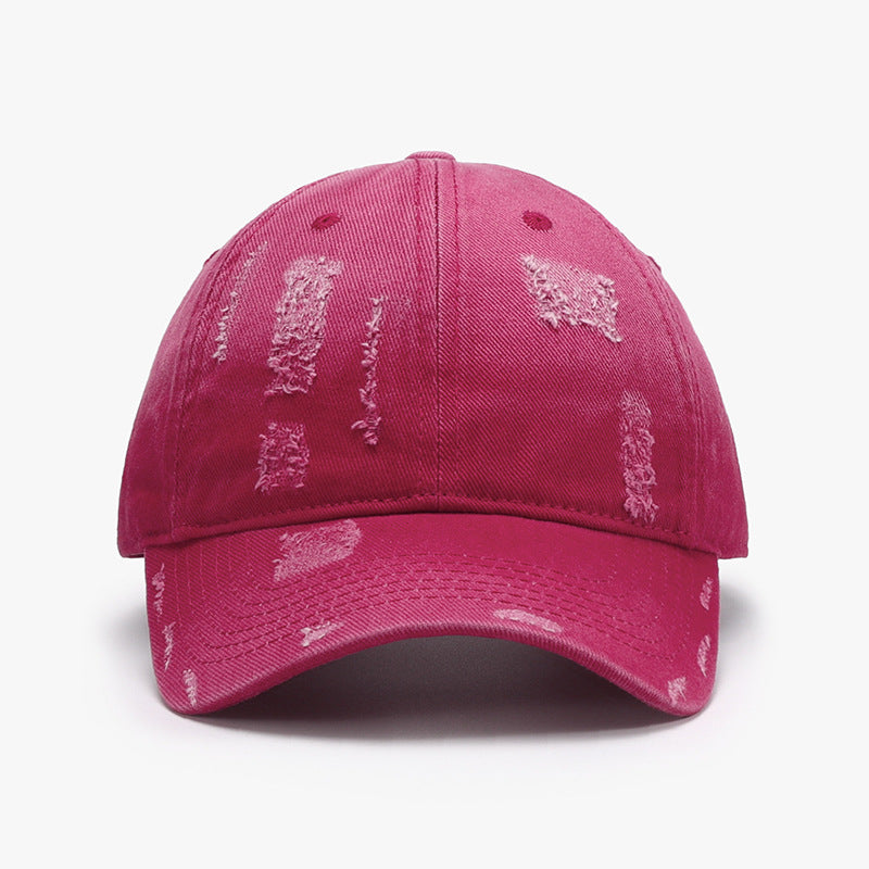 Adjustable cotton baseball hat in vibrant pink with distressed design, perfect for casual and stylish looks.
