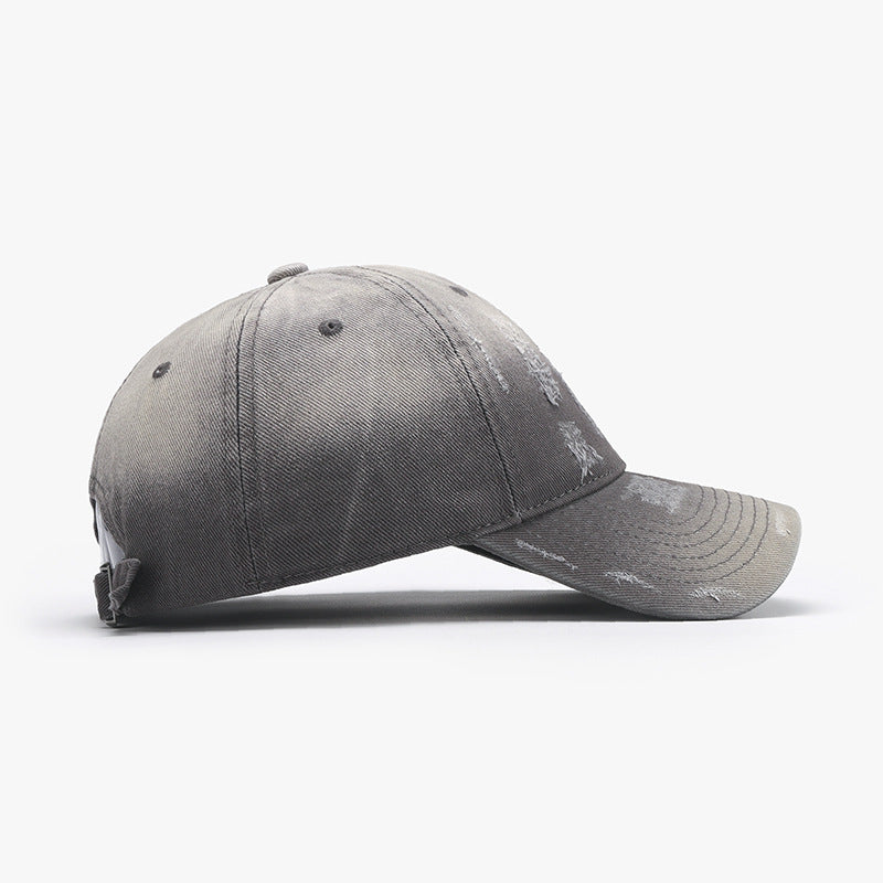 Side view of an adjustable cotton baseball hat in gray with a distressed design, perfect for casual wear.