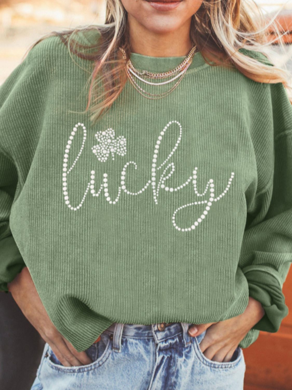 LUCKY rhinestone round neck long sleeve sweatshirt with sparkling embellishments for a chic and comfortable look, available at 6i6.com