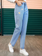 Heart-shaped detail on straight leg jeans with side pockets, designed for a stylish and comfortable fit, available at 6i6.com