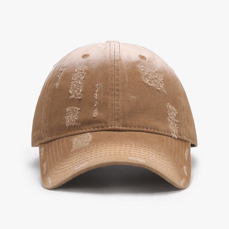 Adjustable cotton baseball hat in tan with a distressed design, featuring a front view and a curved brim. Ideal for casual wear.