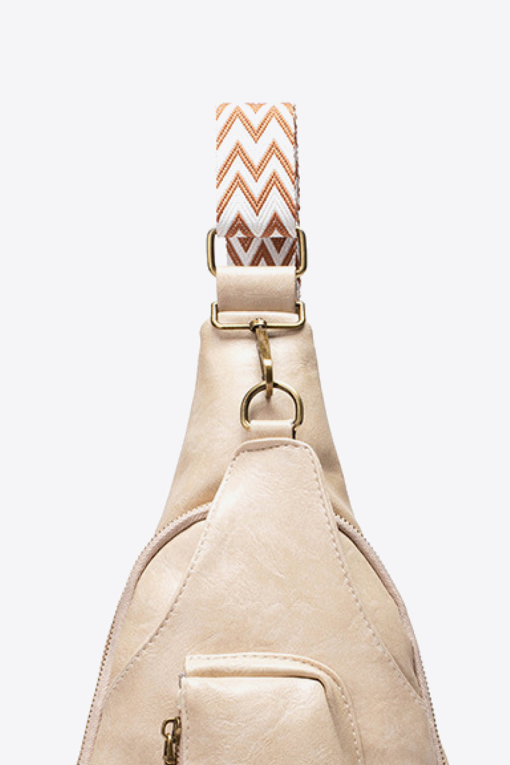 Close-up of adjustable strap on All The Feels PU leather sling bag, featuring a decorative chevron pattern design.
