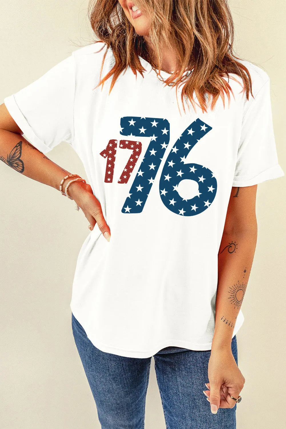 Model wearing a white 1776 short sleeve T-shirt featuring patriotic star and number graphics.