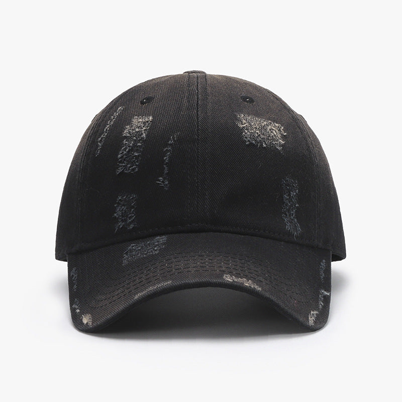 Adjustable cotton baseball hat in black with distressed details, featuring a curved brim for a stylish look.