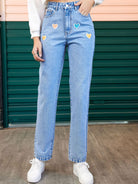 Heart-shaped detail on straight leg jeans with side pockets, designed for a stylish and comfortable fit, available at 6i6.com