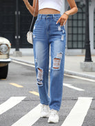 Distressed straight leg jeans with front and back pockets, featuring frayed edges for a trendy, worn-in look, available at 6i6.com