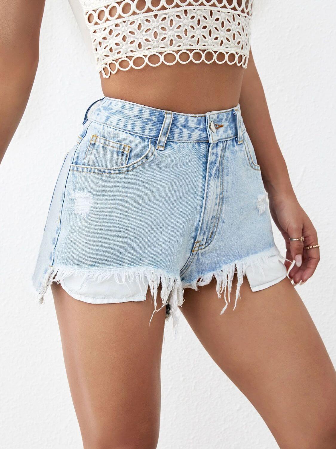 Distressed raw hem denim shorts with a frayed edge and a trendy, worn-in look, available at 6i6.com